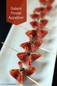 small appetizers are lined up on a white plate