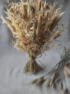 dried flowers are sitting on a gray surface