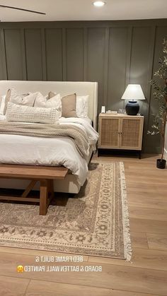 a large bed sitting on top of a hard wood floor next to a wooden dresser