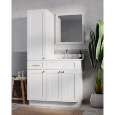 a bathroom with a sink, mirror and cabinet in white wood finish on the wall