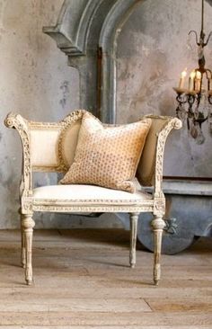 a white chair sitting in front of a chandelier