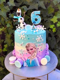 a frozen princess birthday cake on a table