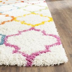 a multicolored rug on the floor in a living room