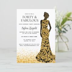 a gold and black wedding card with a silhouette of a woman in a dress on it