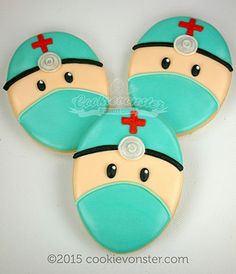 two cookies shaped like mickey mouses with red crosses on their heads and eyes, one in the shape of a doctor's hat