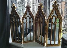 three decorative mirrors sitting on top of a window sill