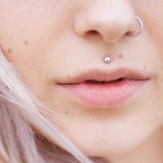 a close up of a person with a nose ring