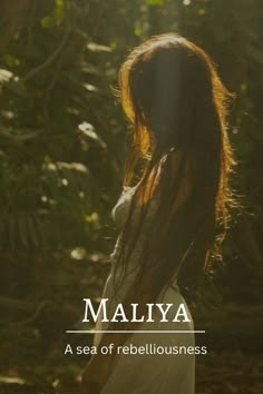 a woman with long hair standing in front of some trees and bushes, text reads malya