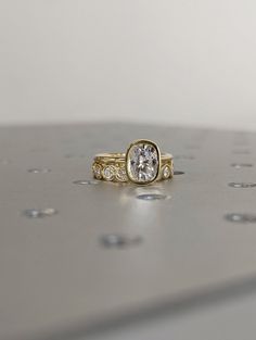 a close up of a ring on a surface with drops of water in the background