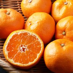 a basket filled with oranges sitting on top of a table