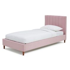 a pink bed with white sheets and pillows