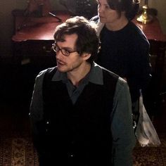 two young men standing in front of a desk