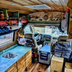 the interior of an rv with wood floors and blue counter tops