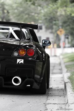 a black sports car parked on the side of the road