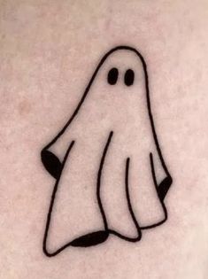 a ghost tattoo on the back of a woman's stomach