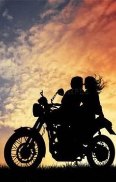 two people sitting on a motorcycle with the sun setting in the background and clouds behind them