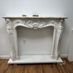 a white marble fireplace surround in a room