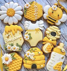 decorated cookies are arranged in the shape of honeycombs and beehives with daisies