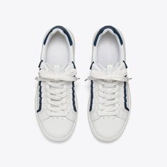 Our classic court sneaker — inspired by a '70s-era tennis shoe — is updated with our signature emblems: a decorative ruffle and Double T. The Howell is lightweight and comfortable, featuring a cushioned footbed and a flexible outsole. Tennis Sneakers With Vulcanized Sole Lace-up, Lace-up Tennis Sneakers With Vulcanized Sole, White High-top Lace-up Sneakers For Tennis, Custom Sporty Lace-up Tennis Sneakers, Spring Tennis Low-top Sneakers, Spring Tennis Lace-up Sneakers, Spring Low-top Tennis Sneakers, 70s Era, Footwear Design Women