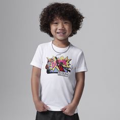 This tee is for the kid who loves comics and bball. It's made of soft cotton/poly jersey, has a tagless crewneck for a comfy feel and pairs well with any Jordan bottoms for a coordinated look. White T-shirt With Cartoon Print For Fan Conventions, White T-shirt With Character Print For School, White School T-shirt With Character Print, White Character Print T-shirt For School, Playful Pre-shrunk T-shirt For Streetwear, Playful Graphic T-shirt For Streetwear, Playful Letter Print Fan Merchandise T-shirt, White Graphic Design T-shirt For School, Playful Letter Print Fan T-shirt