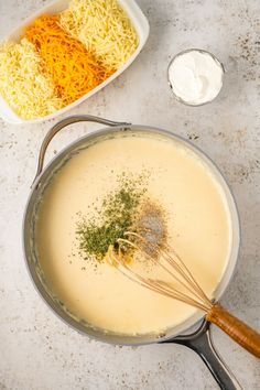 a pan filled with cheese and other ingredients next to a bowl of sour kraut