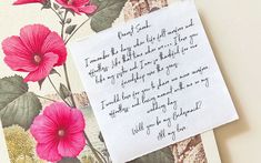 a piece of paper with writing on it next to a flowered wallpaper background