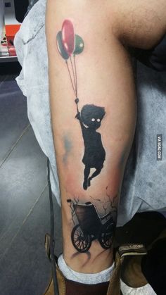 a person with a tattoo on their leg that has a dog and balloon attached to it