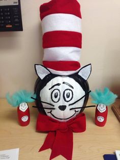 the cat in the hat is sitting on the desk