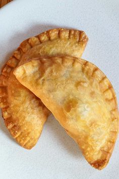 three pieces of pie sitting on top of a white plate