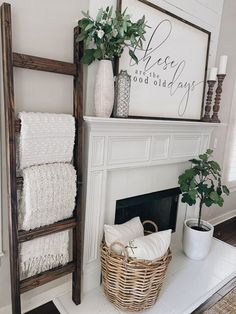 a white fireplace with purple accents and towels on it's mantel in the living room