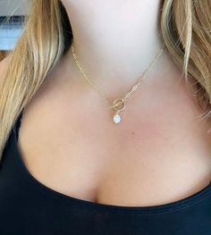 D E S C R I P T I O N Pearl + Paperclip Toggle Clasp Necklace *Materials: 14k Gold-Plated, Freshwater pearl *Chain: 2 x 6 mm paperclip chain links, 14k Gold Plated *Closure: Toggle Clasp, 14k Gold Plated Gold-Plated Care Instructions: 1. Remove before showering, swimming, or exercising (avoid sweat, chlorine, etc) 2. Place in bag or box when not wearing (avoid direct sunlight when not wearing) 3. Avoid chemical contact (nail polish remove/acetone or chlorine from pool water, for example) Want yo Everyday Gold Toggle Necklace With Pearl Charm, Gold Toggle Necklace With Pearl Pendant As Gift, Pearl Jewelry With Toggle Clasp As A Gift, Pearl Jewelry With Toggle Clasp For Gift, White Toggle Necklace With Pearl Chain, Gold Pearl Toggle Necklace Gift, Minimalist Pearl Pendant Toggle Necklace Gift, Dainty Pearl Necklace With Paperclip Chain Gift, White Toggle Necklace With Pearl Pendant As Gift