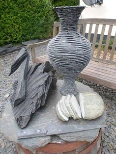 a large vase sitting on top of a stone slab