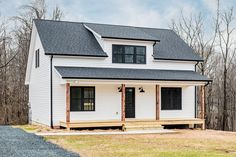 a white house with black roof and windows