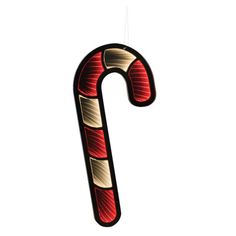 a candy cane shaped ornament hanging from a string on a white background with clippings