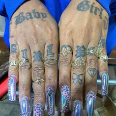 two hands with different designs on them and one has tattoos on their fingers, while the other is wearing rings