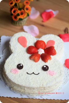 a white cake with strawberries on top of it