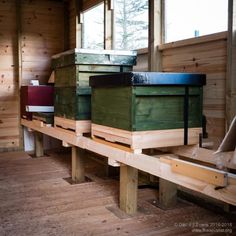 several beehives are stacked on top of each other in a room with wood flooring