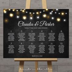 a chalkboard sign with lights on it that says, claudia and parker wedding seating