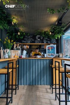 the interior of a restaurant with wooden tables and stools