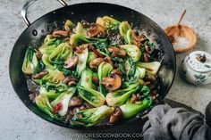 stir fry with mushrooms, broccoli and other vegetables in a wok on the counter