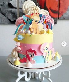 there is a cake decorated with many little ponys