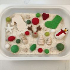 a plastic container filled with sand and toys