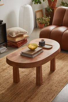 a living room with a couch, coffee table and other items on the rugs