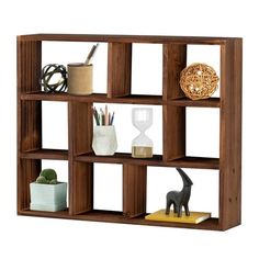 a wooden shelf filled with assorted items on top of each other in front of a white background