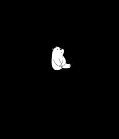 a white polar bear sitting on its hind legs in the dark, looking at something