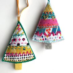 two ornaments are hanging on the wall