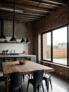 an open kitchen and dining room with large windows