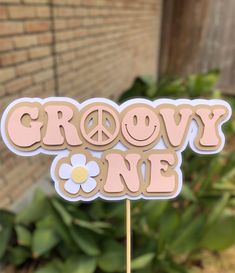 a cake topper with the words grow one on it