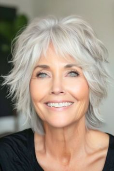 Silver Tapered Shag Hairstyle on smiling woman in her 60s. Shag Hairstyles Medium Wavy Hair, Short Flicked Out Hairstyles, Gray Shag Hairstyles Silver Hair, White Hair With Blonde Highlights, Shaggy Short Hair Cuts, Asymmetrical Shag Haircut, Shorter Shag Hairstyles, Hair Styles For Women Over 70 Grey, Shag Hairstyles Medium No Bangs