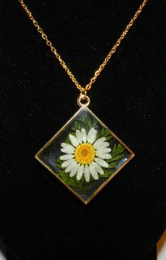 "* White Daisy Real Flower Diamond Bezel Pendant Resin Necklace * Real Dried Flowers * 30mm Width x 33mm Height Pendant. * 18\" Premium Gold Plated Chain Link Chain, 2mm Thickness. * Nickel-free. * Hypoallergenic. * Suitable for Sensitive Skin. * Lobster Claw Clasp. * Lightweight. * Great gift for Christmas, Mother's Day, Birthday, or Anniversary. * Handcrafted / Handmade Item. * One of a kind gift. * Artisan" Flower-shaped Necklaces With Pressed Flowers For Anniversary, Flower Shaped Necklaces With Soldered Details For Gifts, Flower-shaped Soldered Necklaces For Gifts, Flower Shaped Soldered Necklaces For Gifts, Anniversary Jewelry With Pressed Flower Pendant, Clear Flower Shaped Jewelry Gift, Vintage White Jewelry With Pressed Flowers, Gold Resin Art, Dazzling Earrings